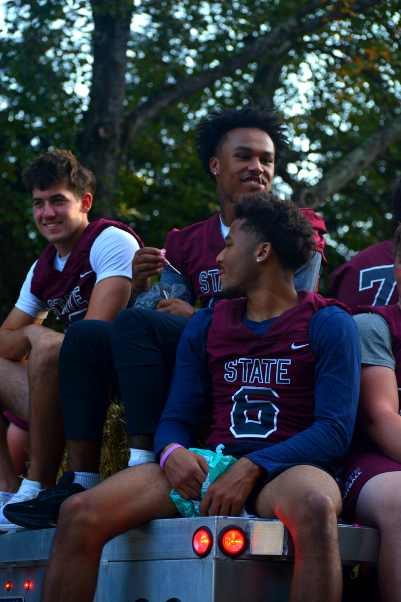 Seniors Hank Lustig, D’antae Sheffey, and Daimear Coad, stars on the football team, cluster on the back of the varsity trailer. On Sept. 19, the three would power the team to a dominant 40-0 victory over Chambersburg. Lustig went for 123 yards and three touchdowns, while Sheffey ran for 115 yards, his third game of the season with over 100 yards.