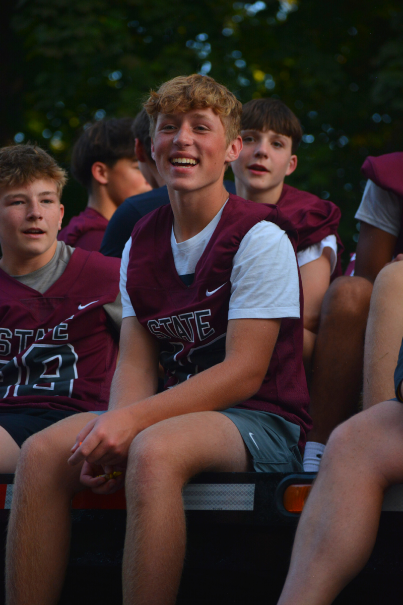 Sophomore Nick Tranell beams with excitement as the JV football team continues on the parade route. “It’s always fun to be a part of the parade, I love seeing people I know…and being with my friends,” Tranell said. The JV football team also defeated Chambersburg earlier in the week.
