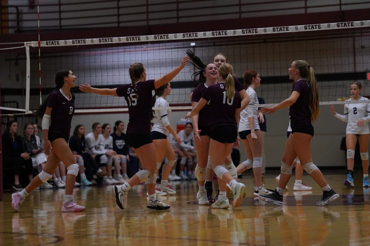 The team celebrates after winning a point in the blowout subregional victory over Erie McDowell.