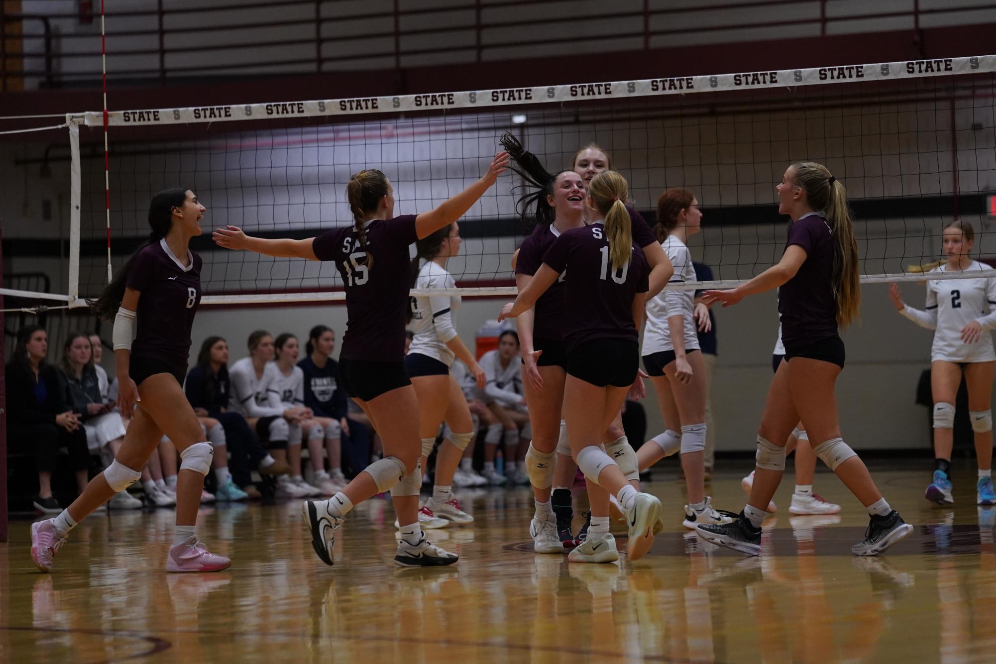 The team celebrates after winning a point in the blowout subregional victory over Erie McDowell.