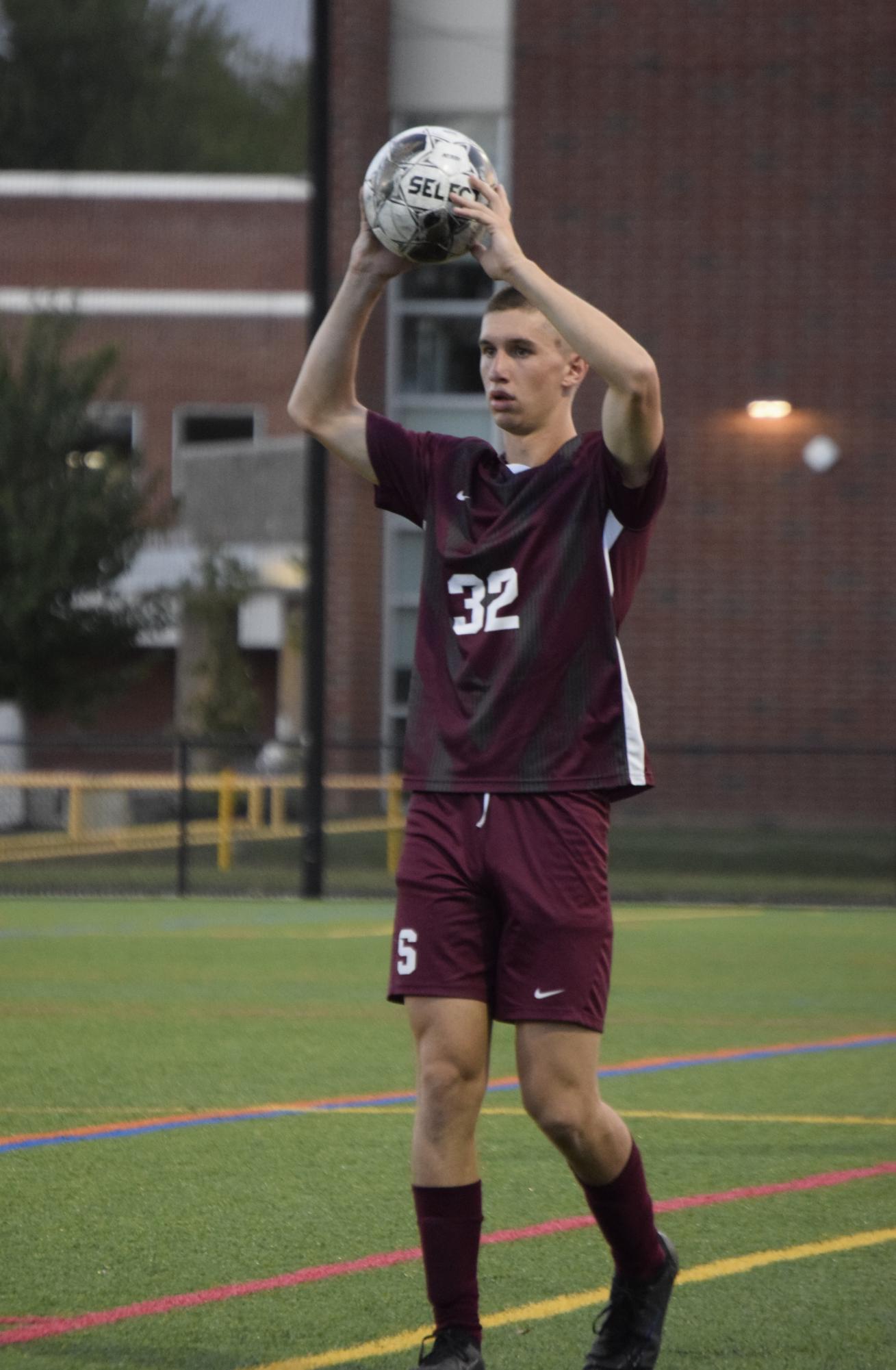 Senior Bryce Dwyer takes a throw-in for State High.