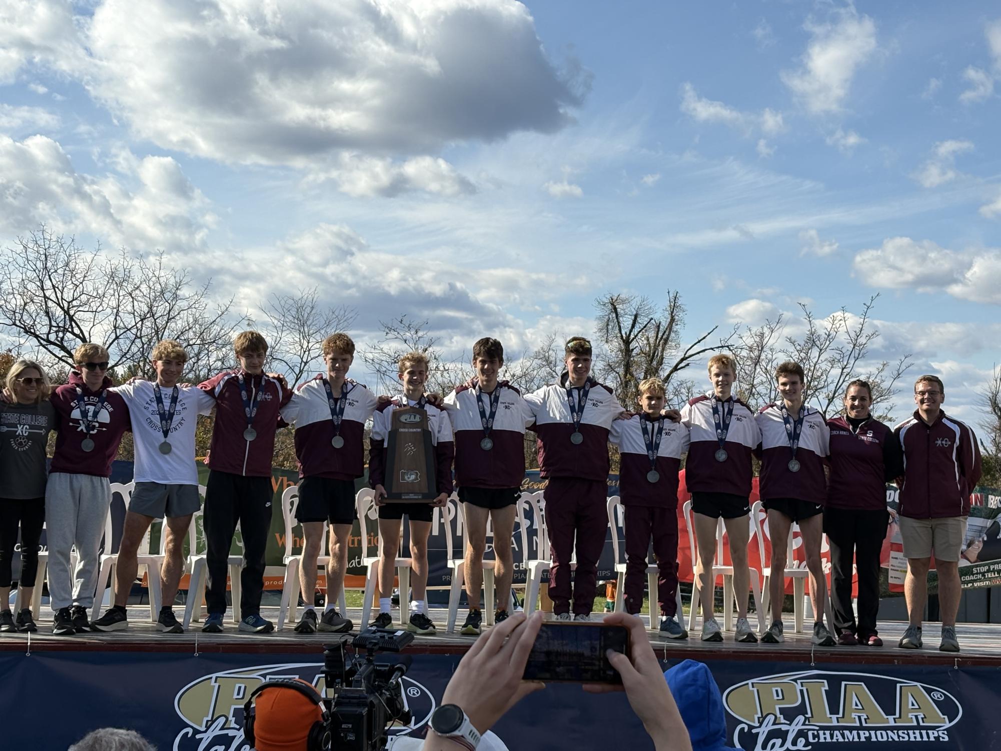 The boys cross country team poses after receiving their runner up medals.