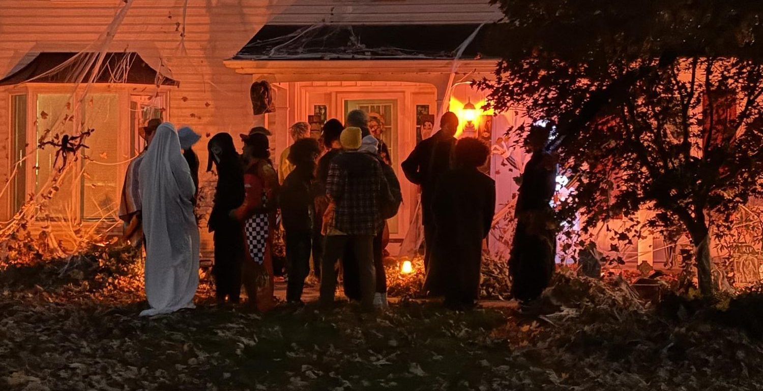 Group of teenagers enjoying trick-or-treating on Halloween night