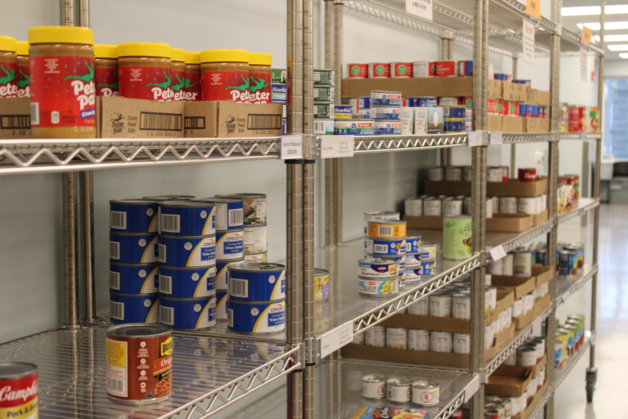Rows of shelves stand lightly stocked in the State College Food Bank.