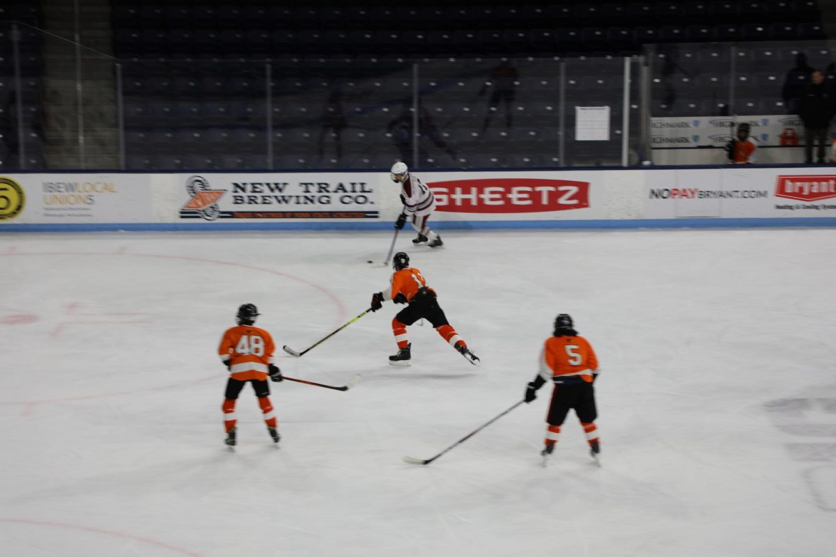 Brady Sides defends the puck against three members of the opposite team.