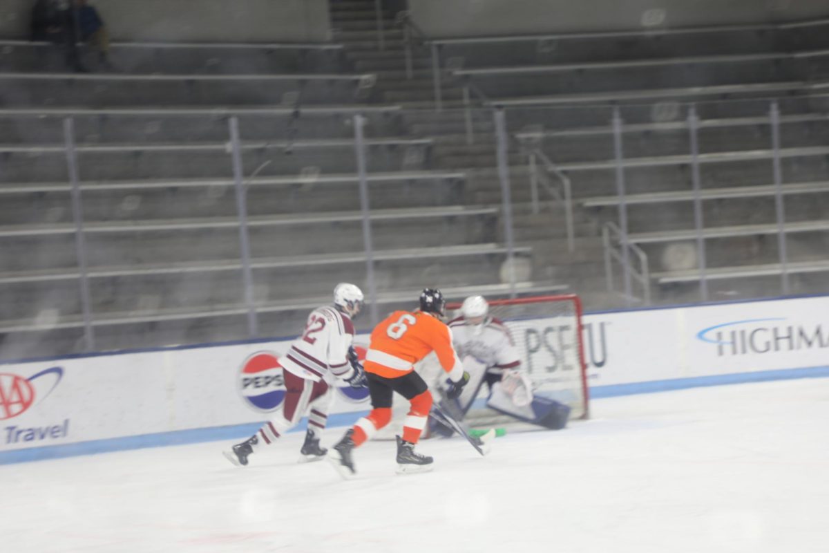 Goalie Bryan Bucher defends the goal from an opponent