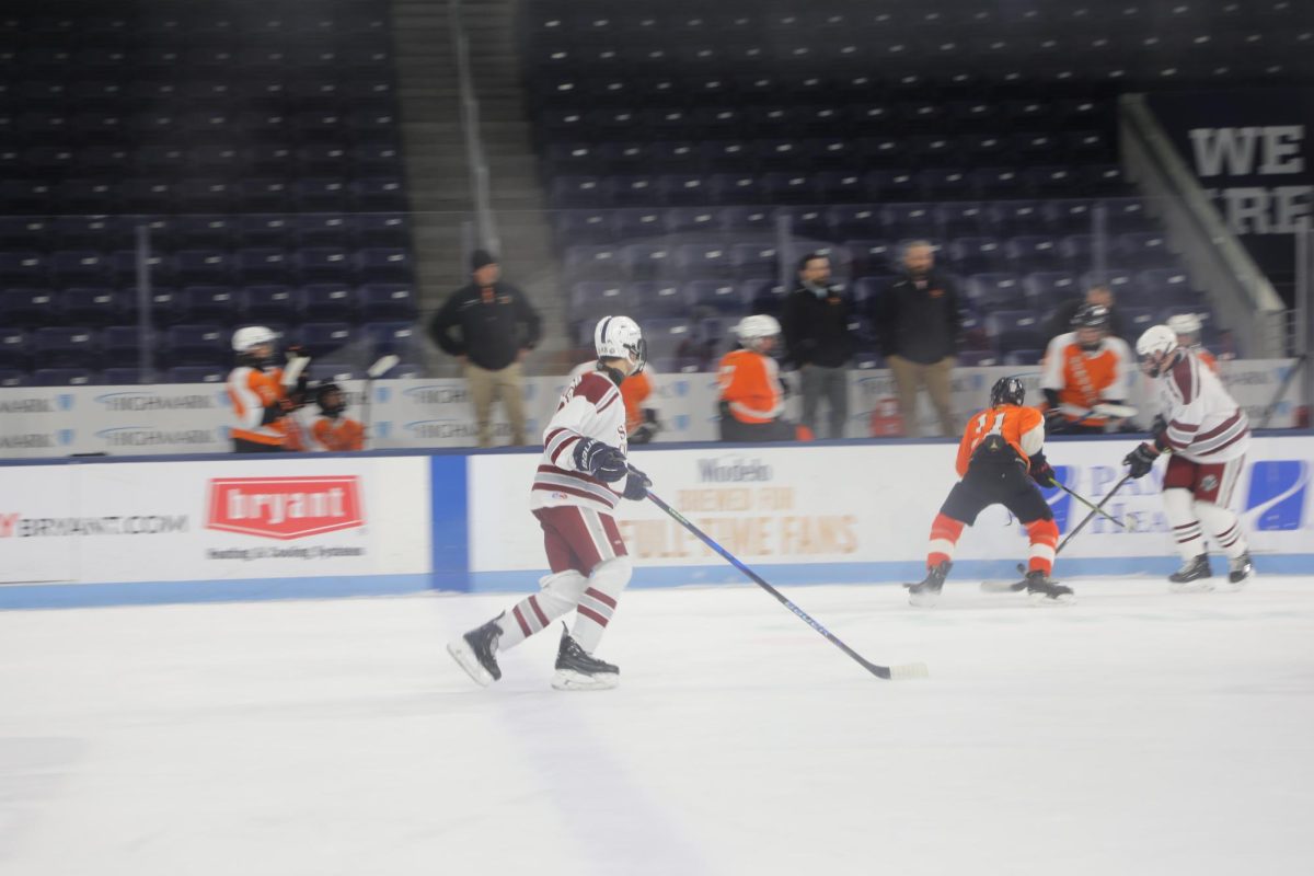 Junior Oliver Brumberg rushes to assist his teammate Lynden Ebeck