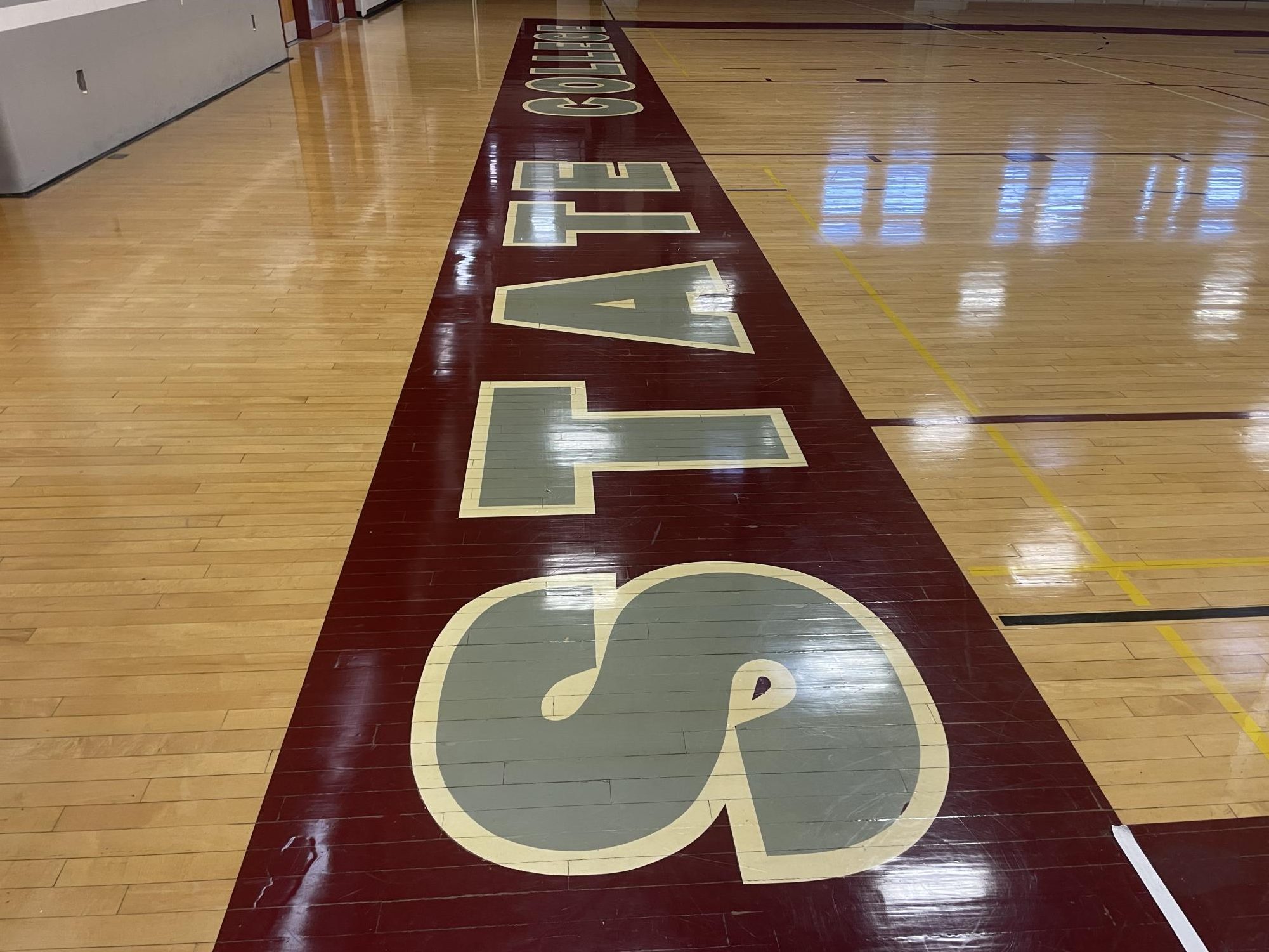 "State College" is written in bold lettering along the baseline at State High's North Gym.