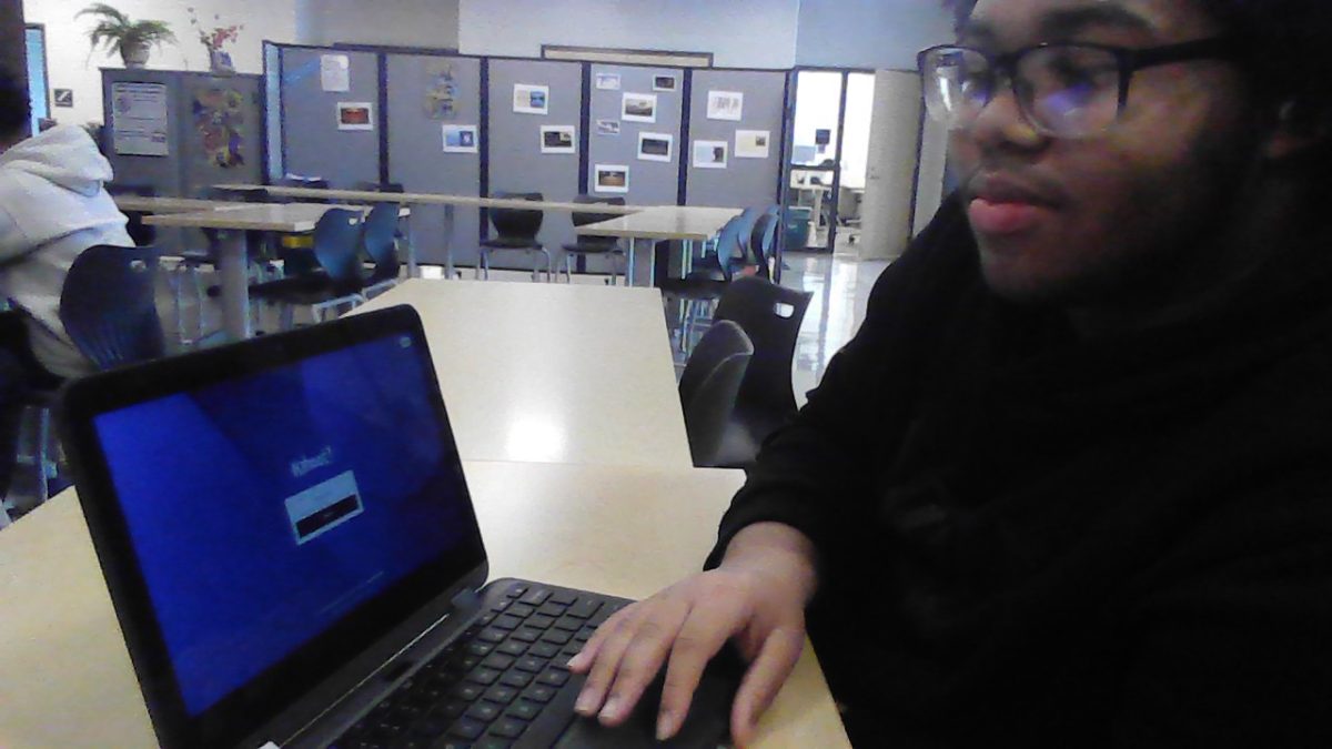 True Write poses for a photo with Kahoot open on his computer.