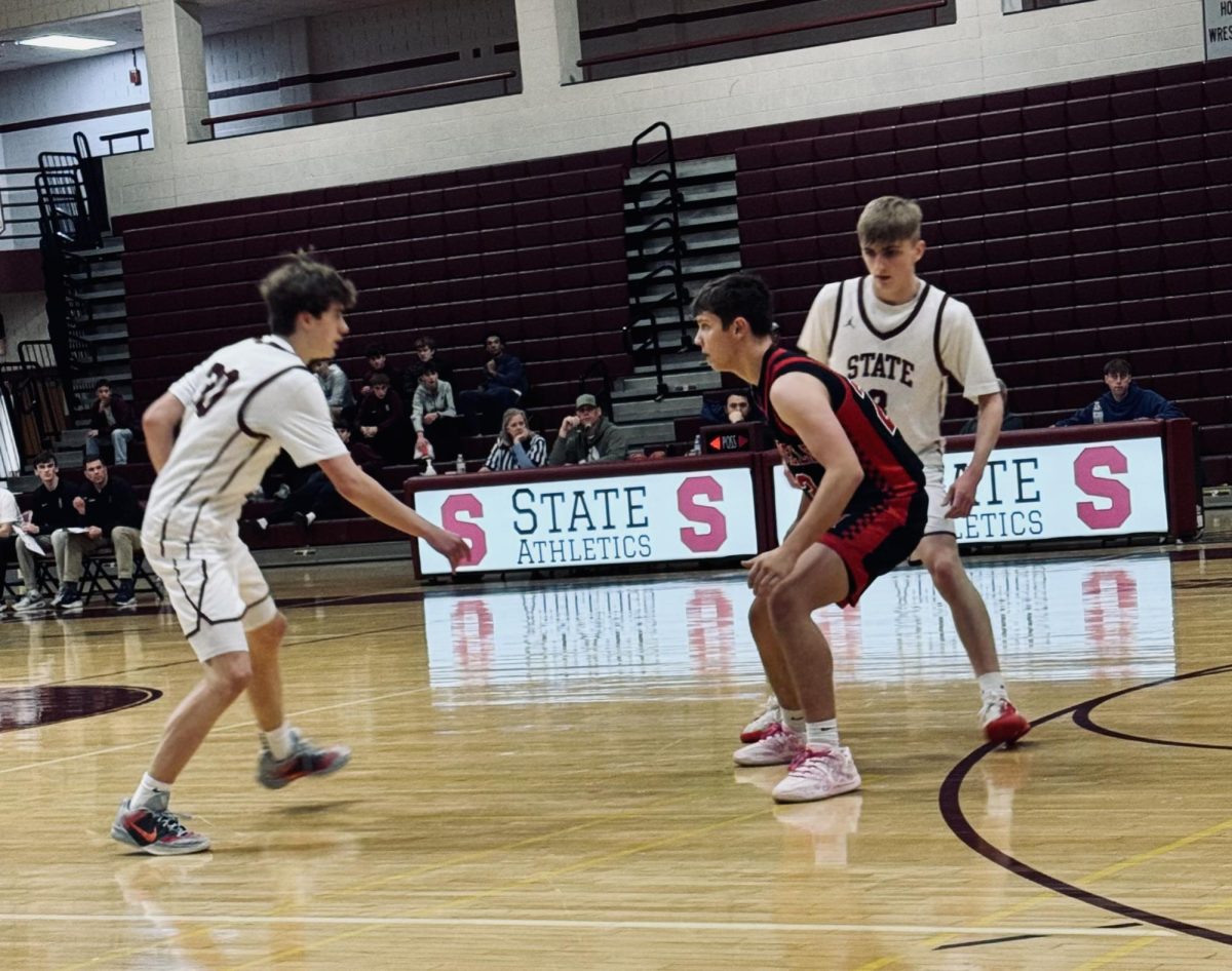 Senior Parker Thurley sets a screen for sophomore Chase Rhoades.