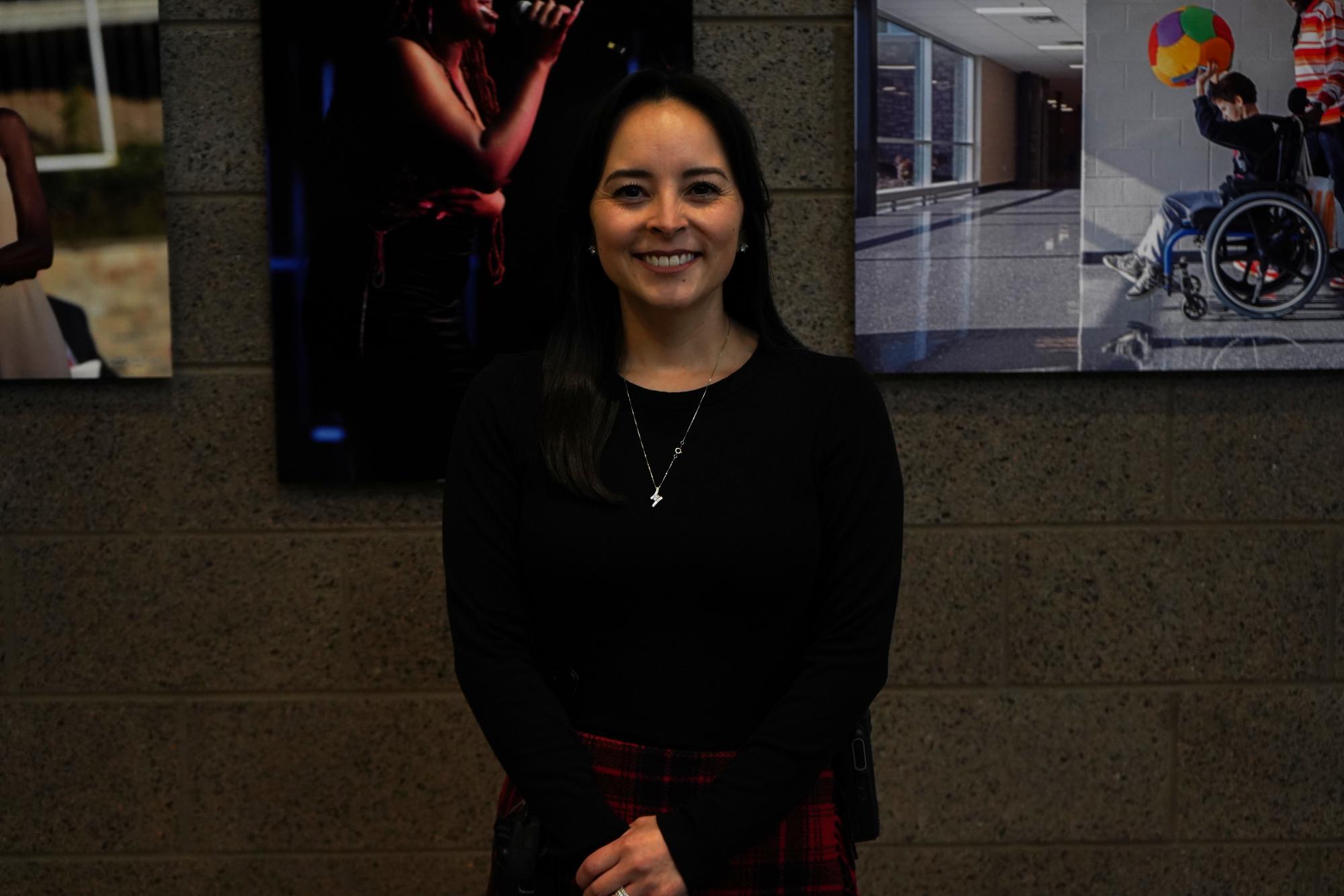 Assistant principal Danielle Ambrosia poses for a photo in front of State High's "Wall of Fame."