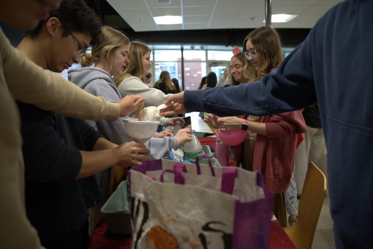 Students build stress balls out of flour and balloons at a station during the Winter Mental Health Summit.