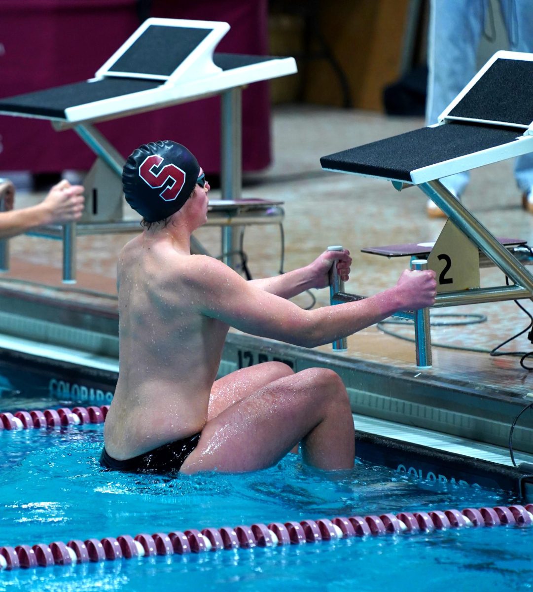 Junior Erik Sulman stands firm to the block as he waits for the start of his 100 yard backstroke. Sulman easily cruised through the event finishing with a 1:03 time alongside his first place finish.
