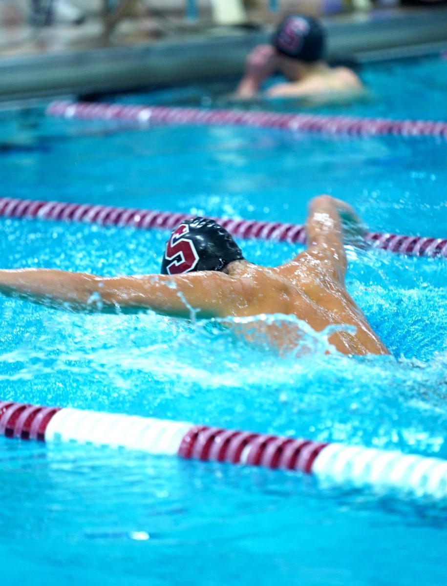 Sophomore Hadrian Zheng rips through the water during his 100 yard butterfly as he finished in second place with a time of 1:01 just behind his teammate Luke Flickinger who had a time of 54.15.
