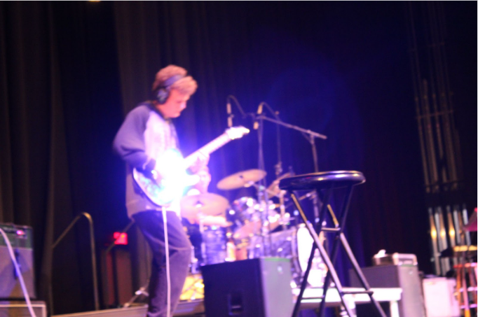 Guitarist Adam Burns performing a solo on guitar.