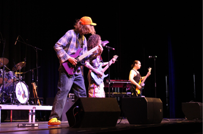 Guitarists (L-R: Aaron Turner, Silas Dudash, and James Lukehart) performing on stage.