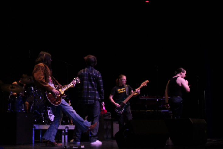 Rock band musicians performing a hit by Killing in the Machines (L-R: Max Jeanmenne, Evan Zorn, Bruno Sanzotti, Declan McGinnis)