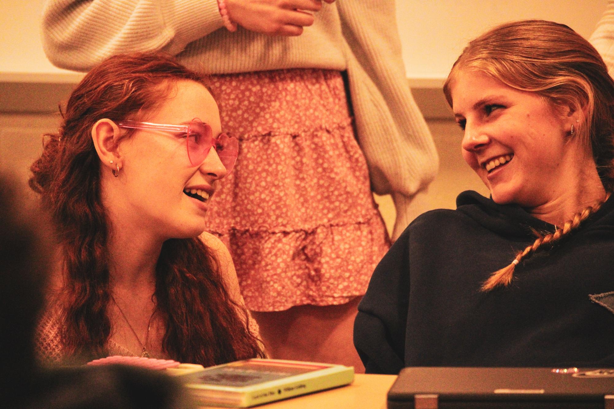 Sophomore Jennie Varrassa sings to sophomore Carolyn Frank mid class. At State High, Vocal Valentines are often bought to embarrass friends, or even just make their day.
