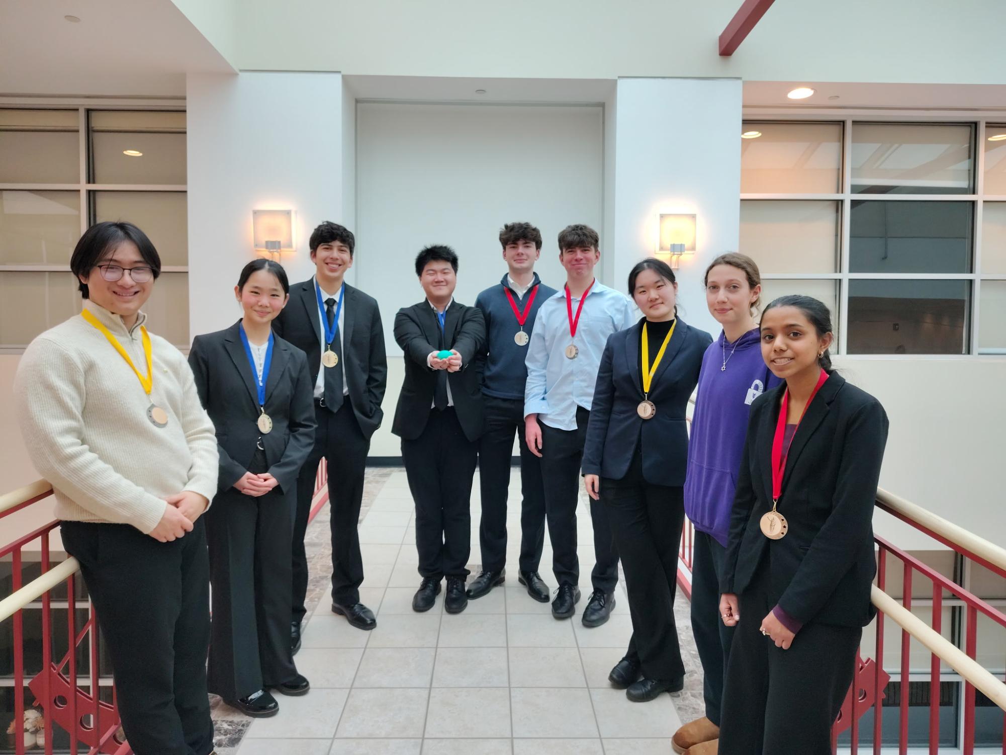 (Left to Right) Aaron Le, Anna Chen, Ricky Nargi, Gilbert Zhao, Sergei Zhdanov, Joseph Janik, Maggie Wang, Lillian Belkin and Sanai Purkait pose for a photo after competing in national qualifiers for Speech and Debate. Photo courtesy of Matt Isham

