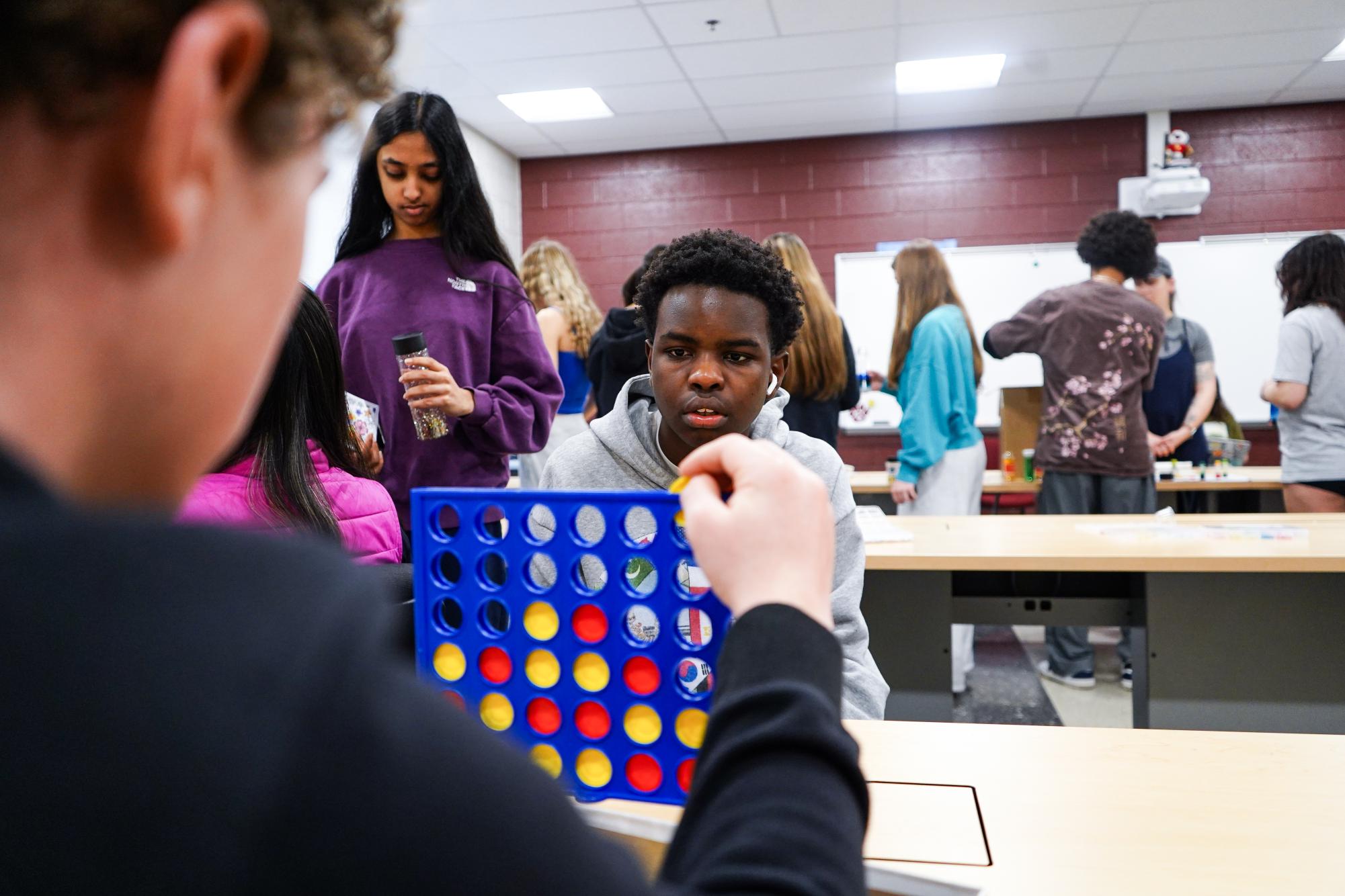Freshman Jake Mwangi focuses on a game of connect 4 with a friend. By offering interactive activities like connect 4, the summit aimed to reduce stress and foster a sense of community among students. Reflecting on the day, Mwangi appreciated the opportunity to “connect with my friends and bring awareness to mental health at the same time.”