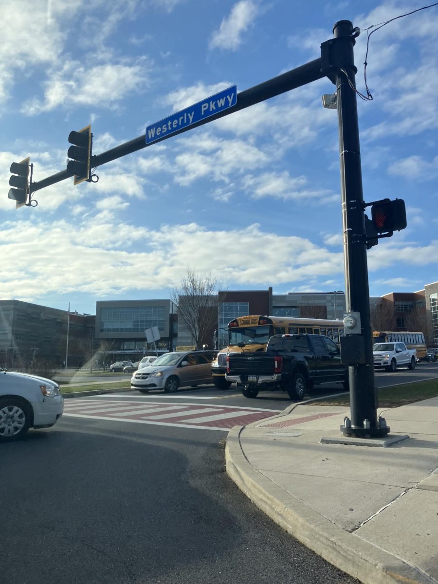 The crosswalk stands facing towards State High as cars drive by.