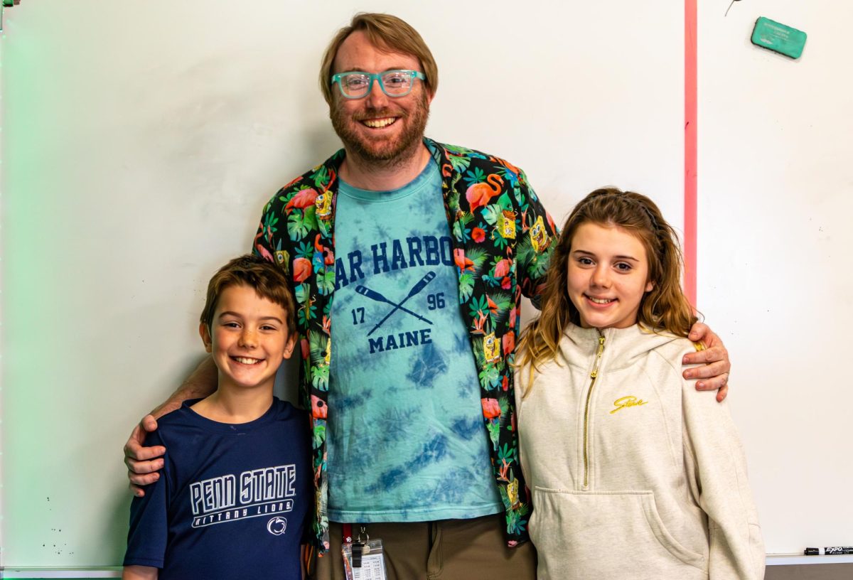 Jared McConkey poses with his two children on Take Your Kid to Work Day on Monday, April 13. 