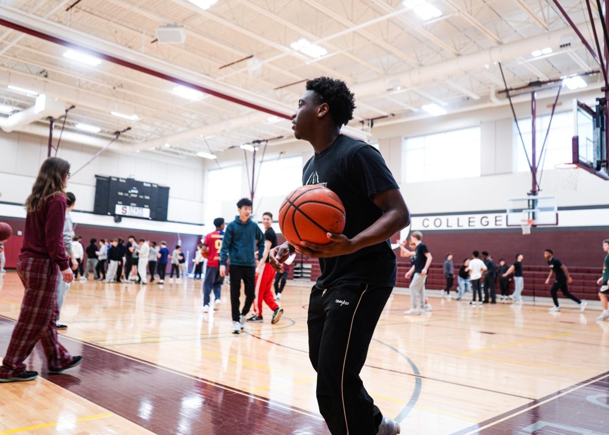 Senior IMBA player Manny Elliot plays basketball in the South Gym during the spring mental health summit.