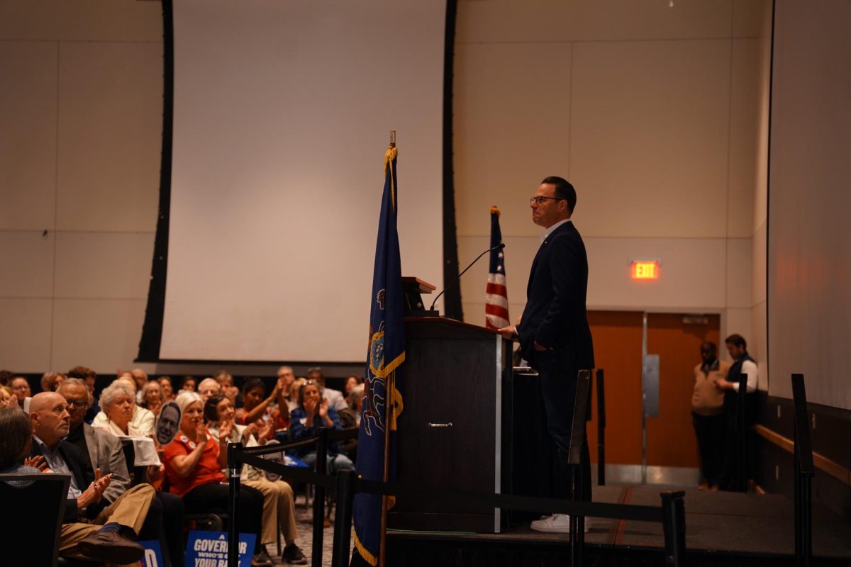 Governor Josh Shapiro pauses in his speech as the crowd cheers.