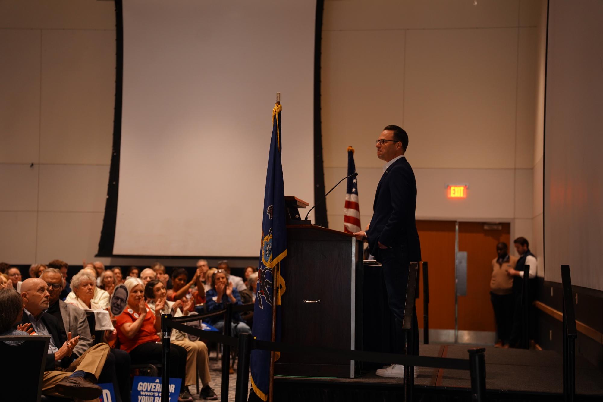 Governor Josh Shapiro pauses in his speech as the crowd cheers.