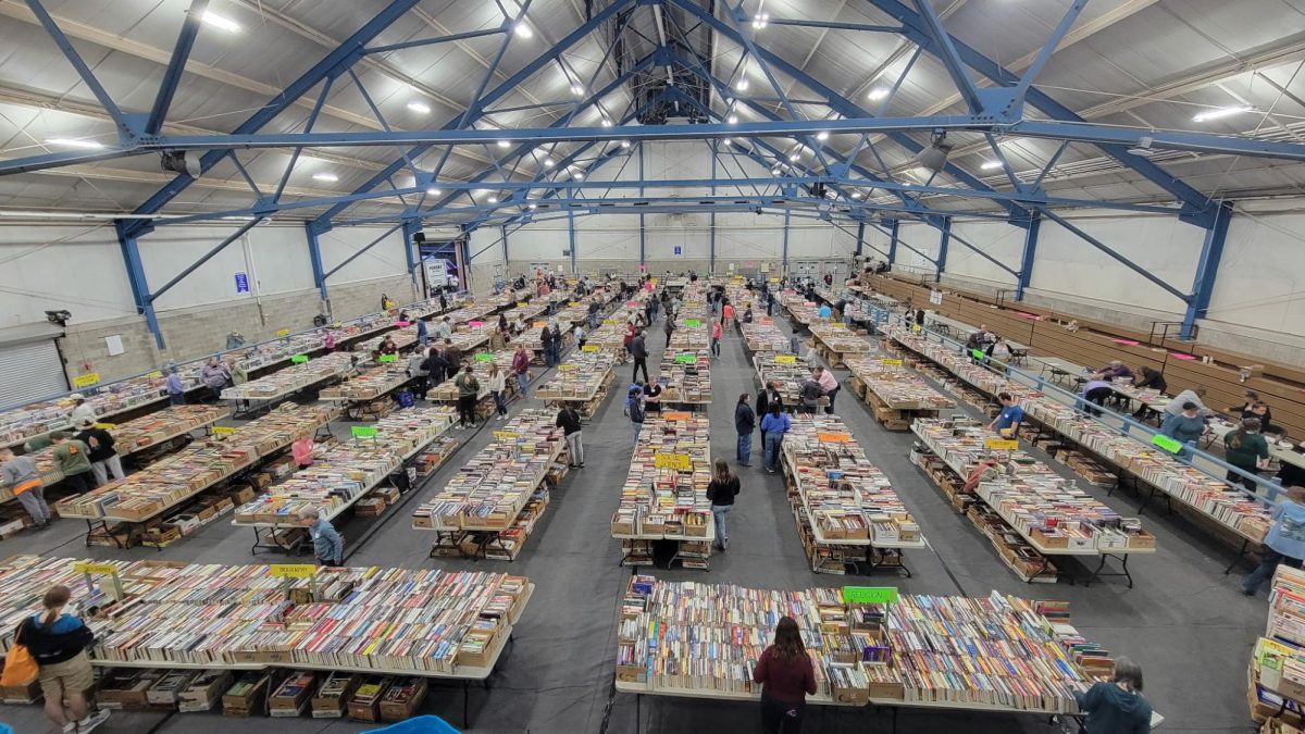Shoppers peruse the packed tables of books at the AAUW Used Book Sale. Photo courtesy of Autumn Shoemaker.