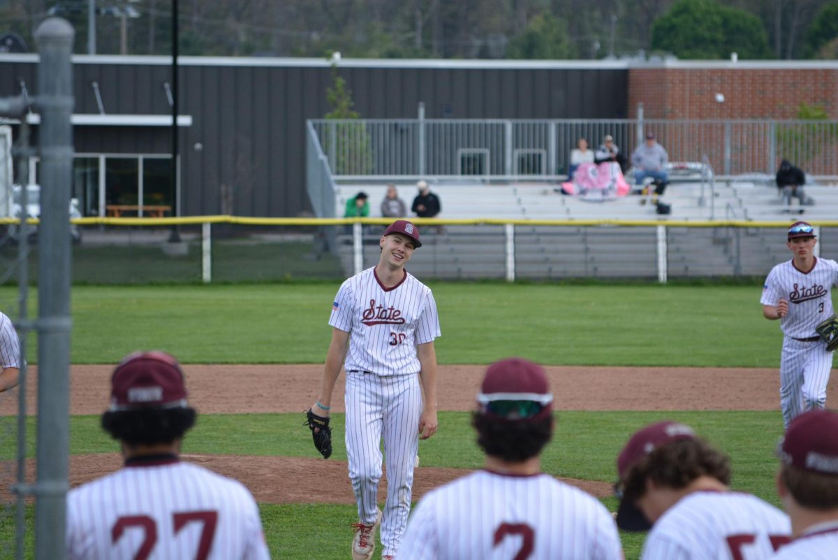 Senior pitcher Cody Norman walks up to his team with a smile on his face in the middle of the first inning. “I am kind of just trying to soak it all in and spend as much time as I can with these boys. I truly am taking in every moment I can with this being my final year of highschool,” Norman said.