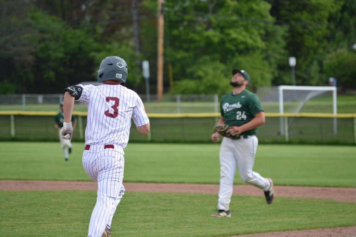 Junior Jack Bierly runs towards first base  during the bottom half of the fourth inning. 