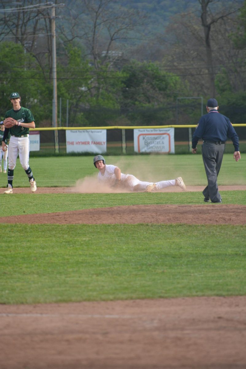 Junior Rowan Walker slides to third base during the bottom half of the second inning with a score of 0-0.