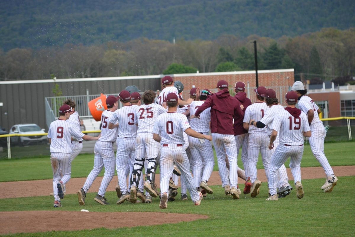 The State High Varsity Baseball Team celebrates its 9-8 victory against Central Dauphin as they dump water on Michael Powell after his walk-off.