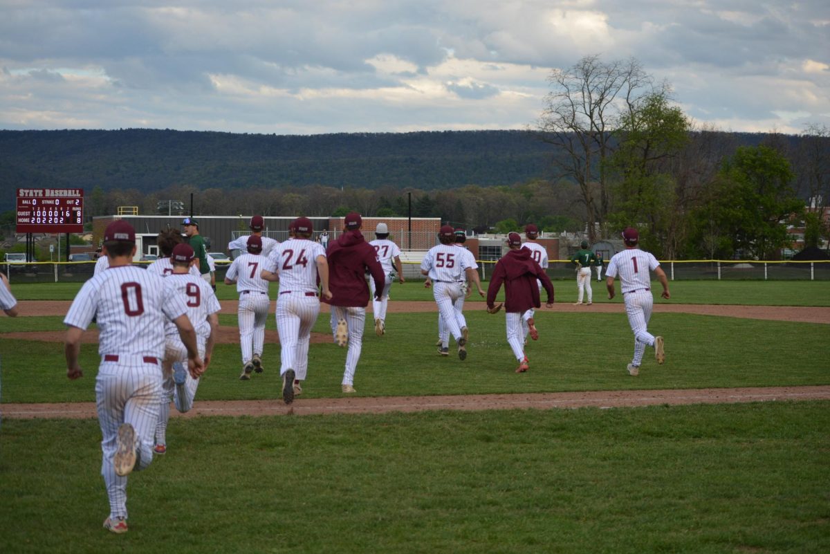 The State High team running on field after they found out they won the game with a score of nine to eight.