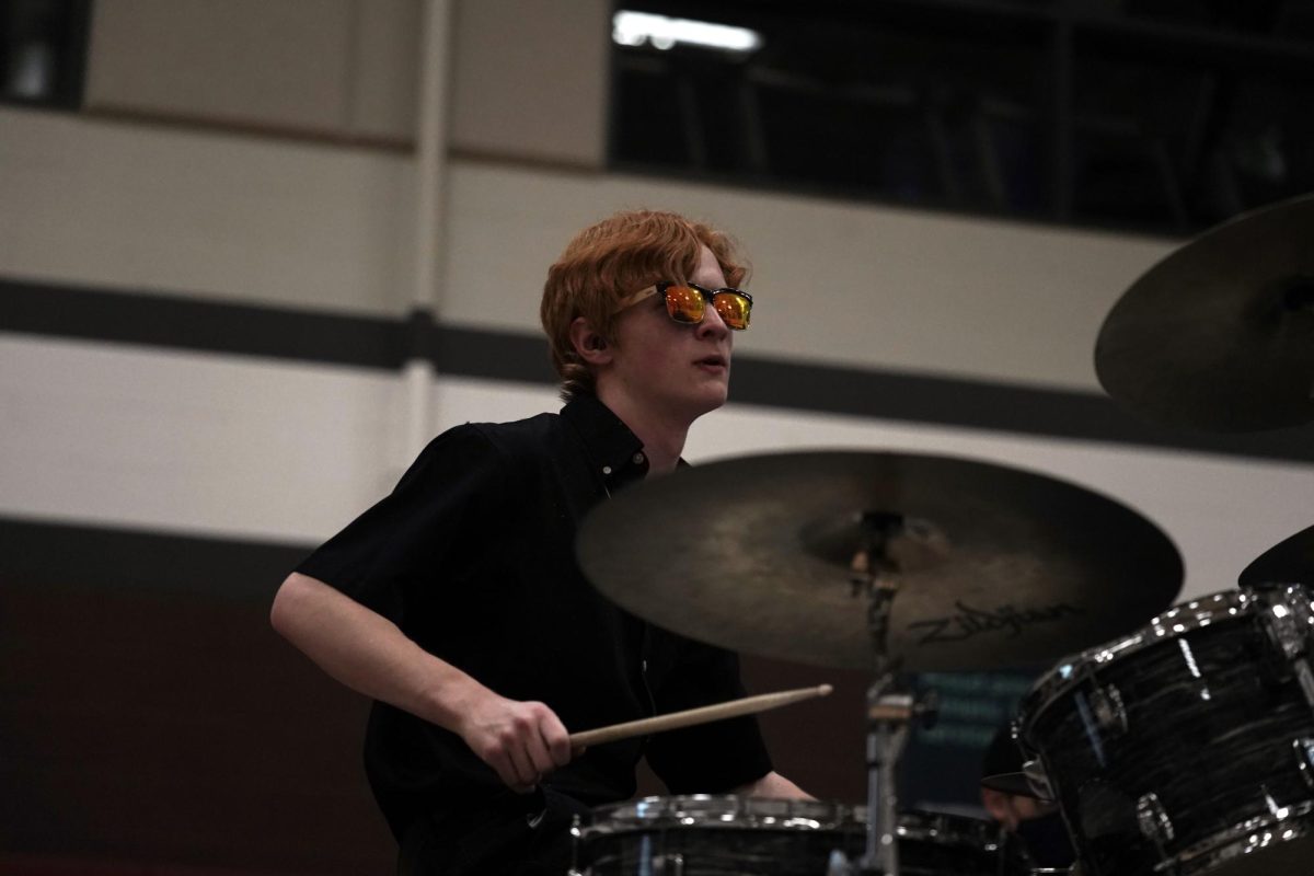 Senior Elliott Mathews plays the drums with his student band, Luminary, at the 2026 Mini-THON event. Student bands like Luminary and the Smash Tacklers are a staple of State High's music scene.