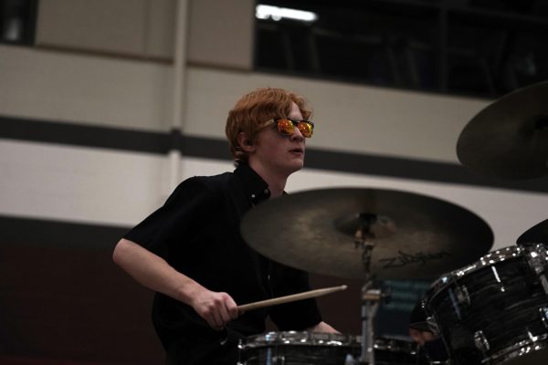 Senior Elliott Mathews plays the drums with his student band, Luminary, at the 2026 Mini-THON event. Student bands like Luminary and the Smash Tacklers are a staple of State High's music scene.