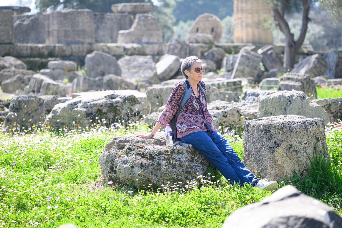 Amy Allison reflects while sitting on a rock. Photo courtesy of Amy Allison.
