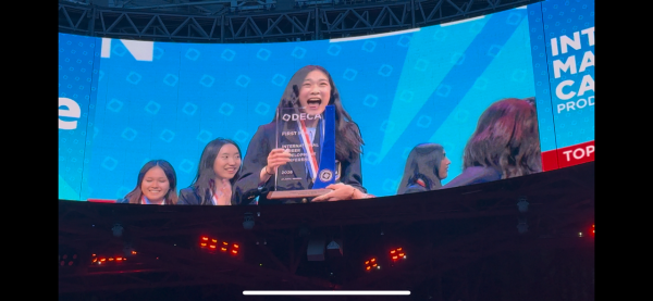 Sophomore Olivia Li is featured on the video board at Mercedes-Benz Stadium after receiving her trophy for State High's first DECA world championship.
Photo Courtesy of Bridget Ciolkosz